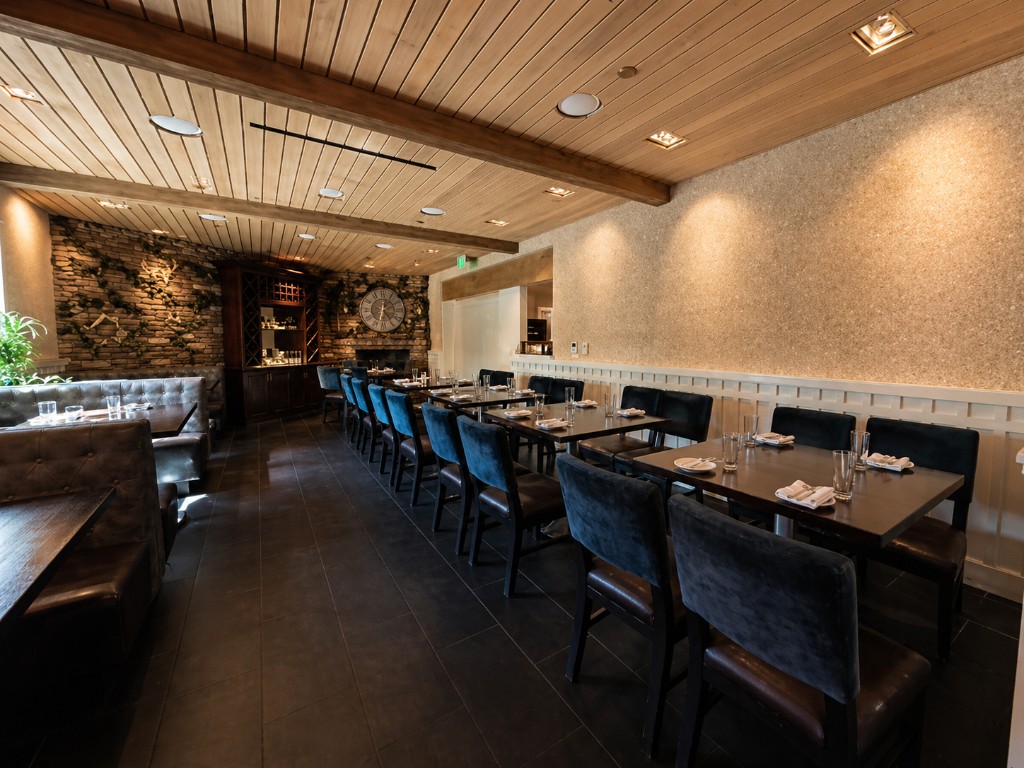 Dining room with fireplace and stone wall